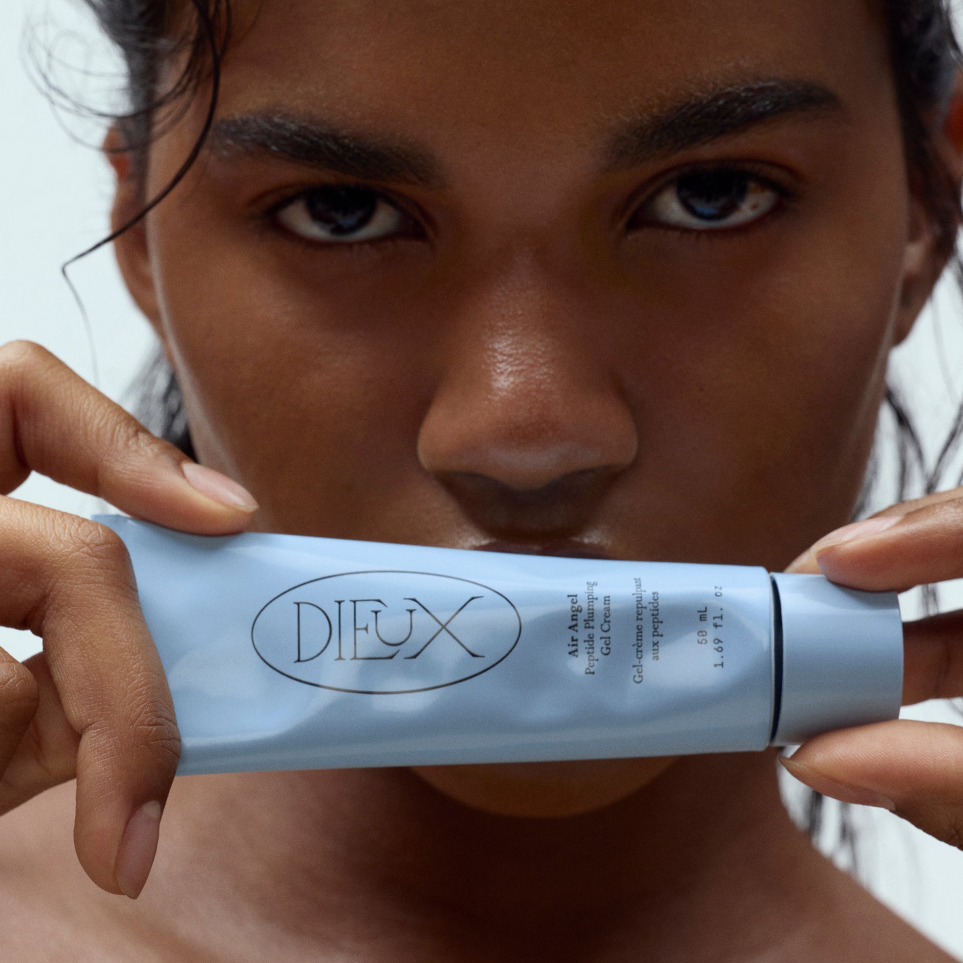 Model holding Dieux Air Angel Gel Cream
