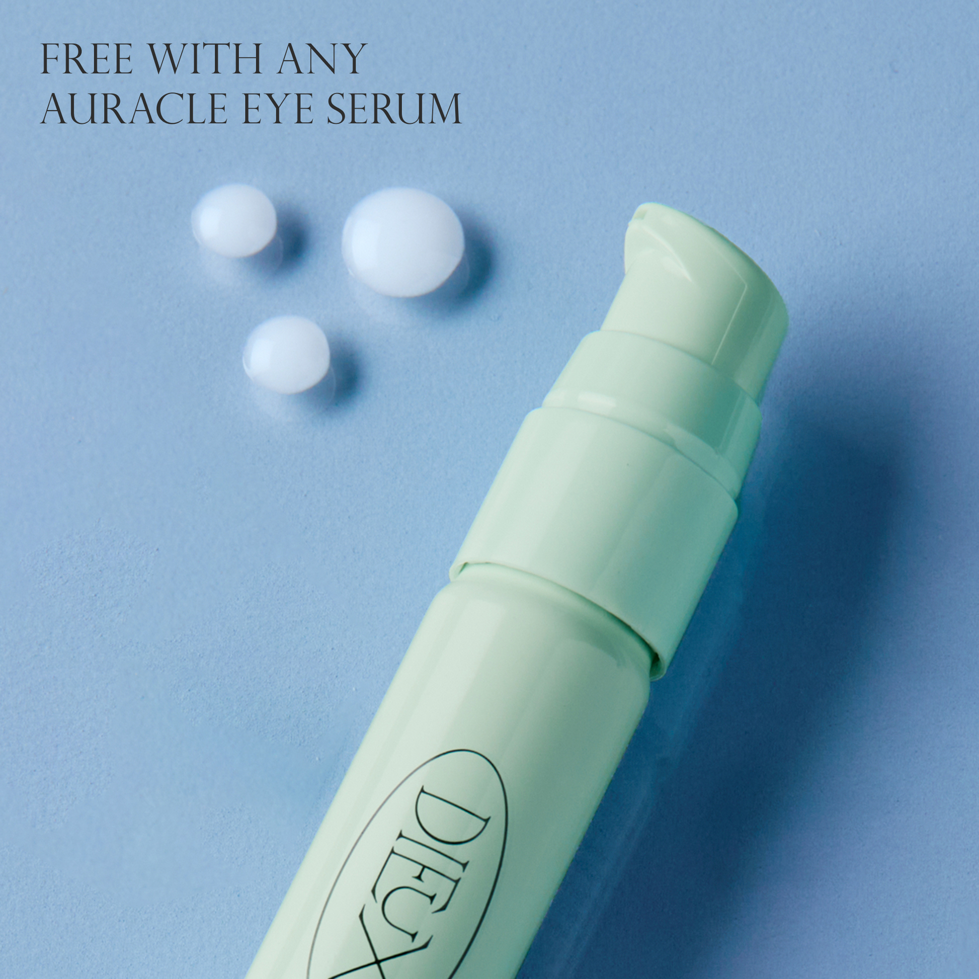 Auracle free gift graphic with eye serum bottle and white spheres