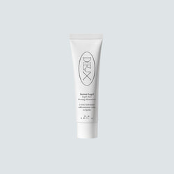 Dieux Instant Angel moisturizer tube on a pale background