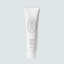 Dieux Instant Angel 100 ml moisturizer tube on a pale background