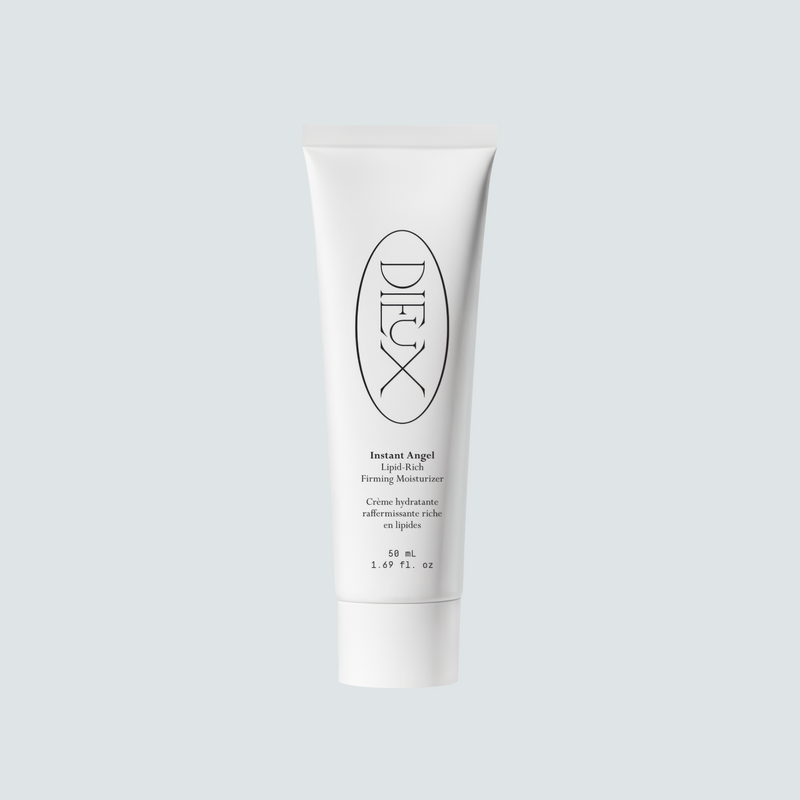 Dieux Instant Angel 50 ml moisturizer tube on a pale background