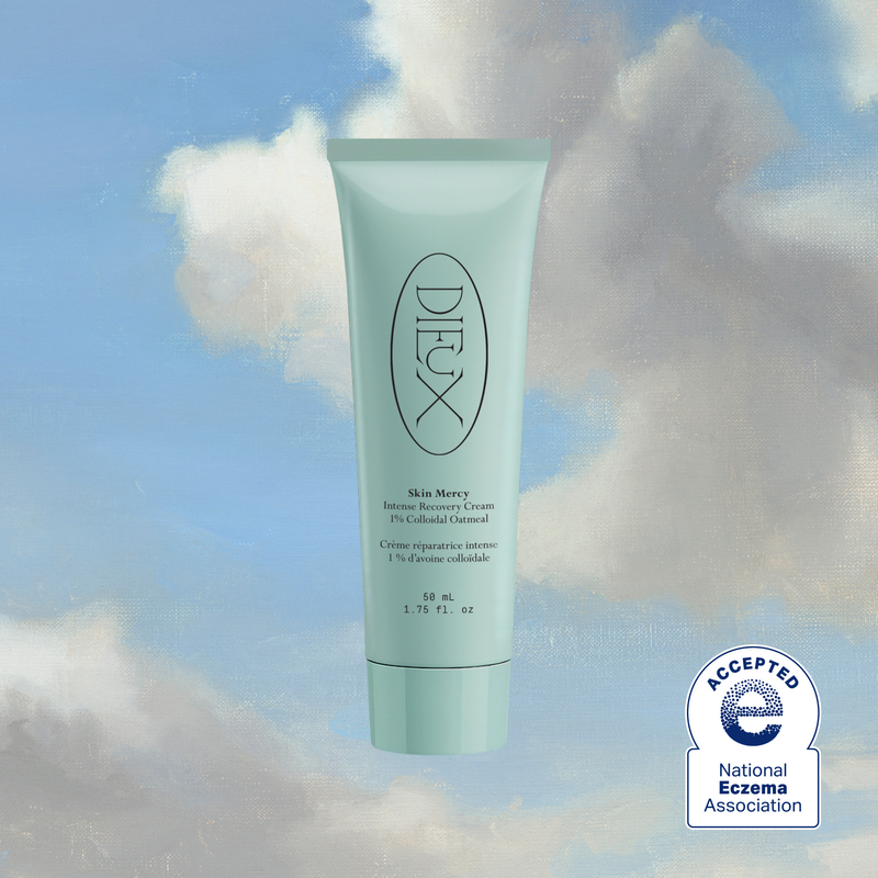 Dieux Skin Mercy Recovery Cream tube with National Eczema Association seal against clouds