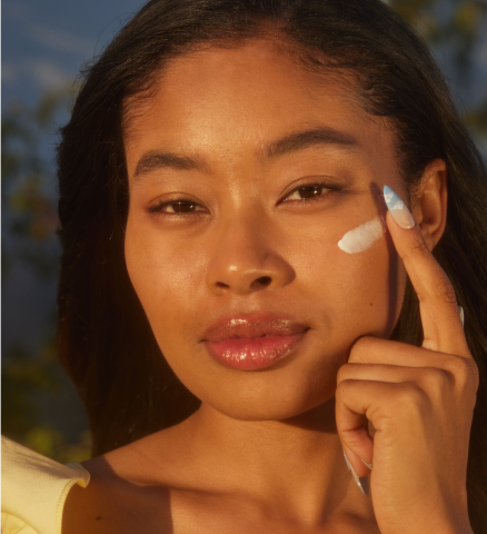 Person applying Instant Angel moisturizer under their eye
