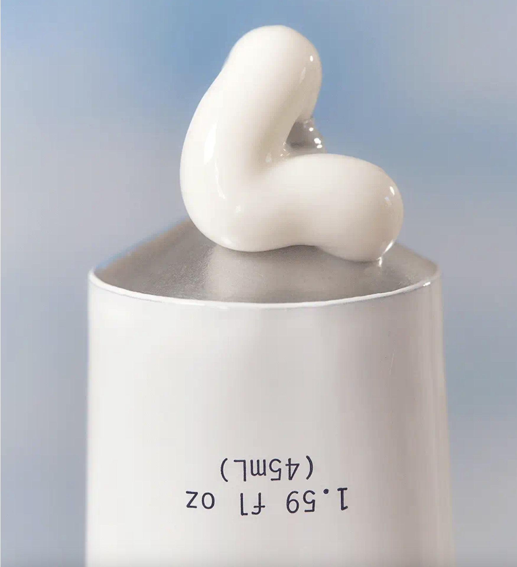 Instant Angel moisturizer texture on a spatula above an open jar